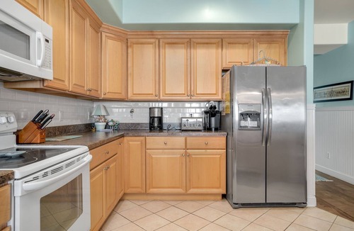 Chincoteague House | Sunset Bay Villa 206 | Luxury Condo w/Waterside Balcony, Gourmet Kitchen + Pool & Fitness