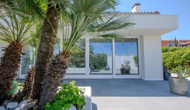 Elegant beachfront villa with jacuzzi, garden, and panoramic terrace.