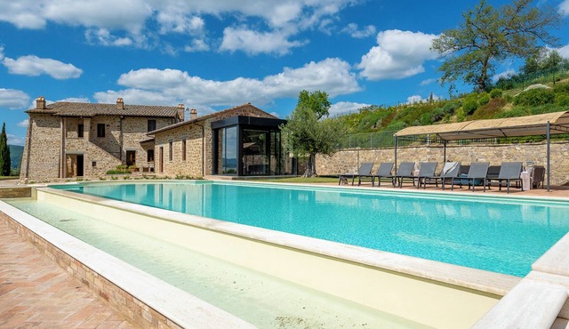 Villa Lago is set against a hillside of luscious greenery olive groves